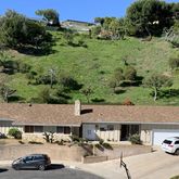 an outdoor view of a house with swimming pool and green space