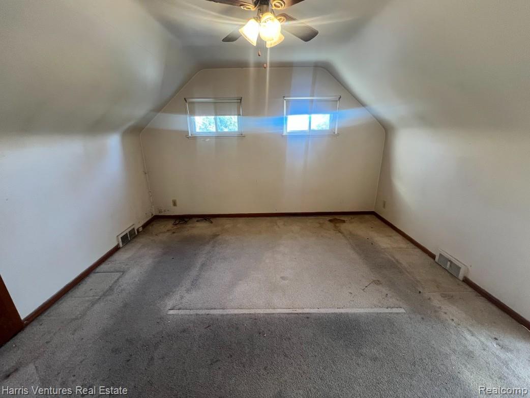 21111-15 Moross Road Grosse Pointe, MI 48236 - Photo 12 of 25 Bedroom with lofted ceiling, ceiling fan, and carpet (upper)