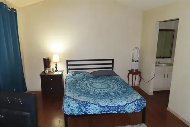 a living room with furniture and a dresser