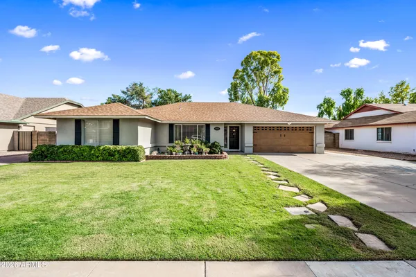 a front view of a house with a garden