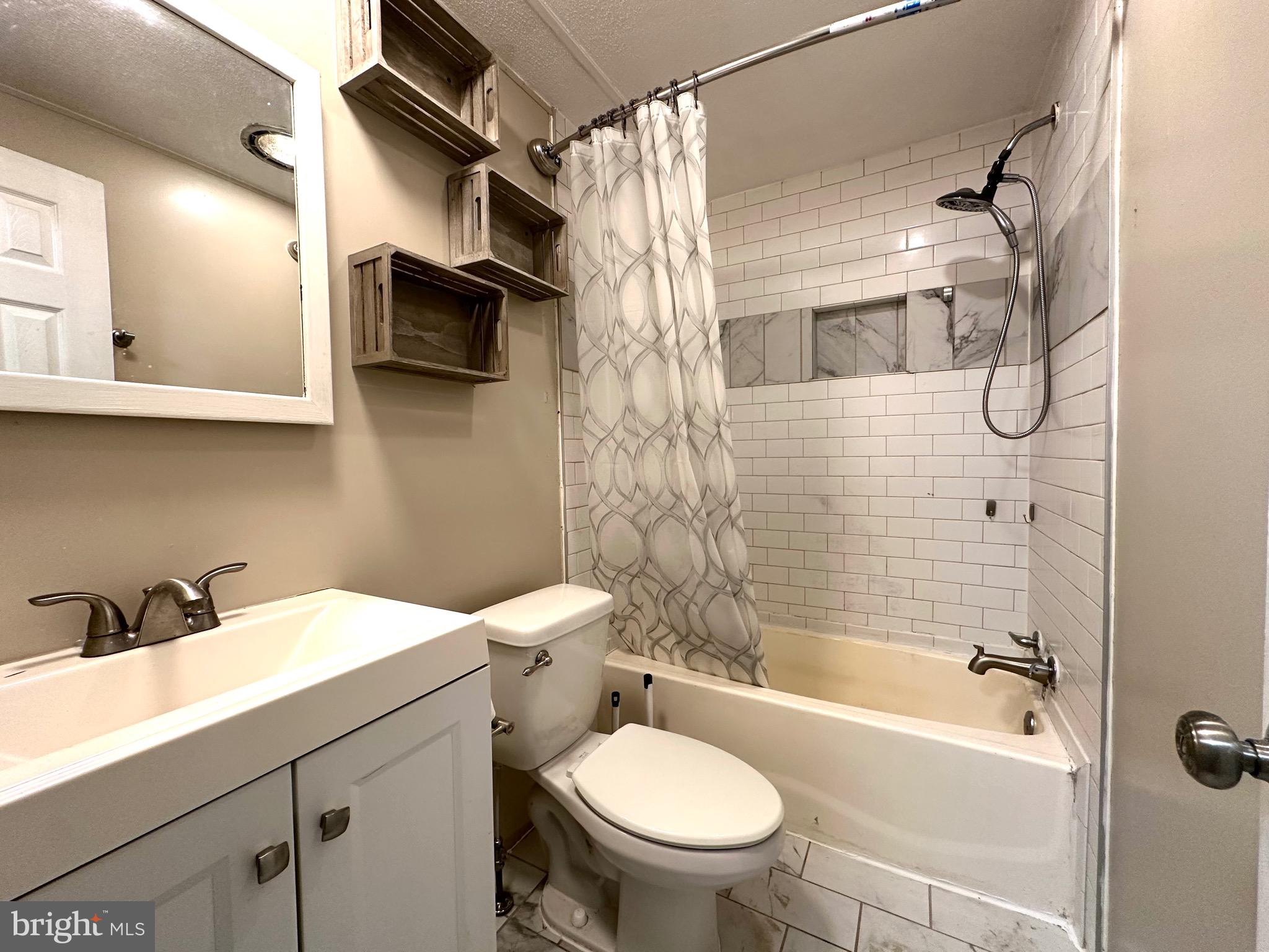 606 Dogwood Acres Road Bumpass, VA 23024 - Photo 10 of 20 a bathroom with a sink toilet and shower