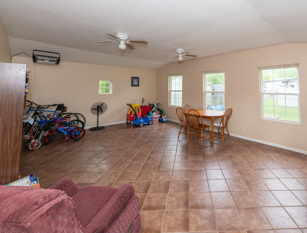 8 Durango Road Montgomery, IL 60538 - Photo 22 of 33 a living room with furniture a window and gym equipment