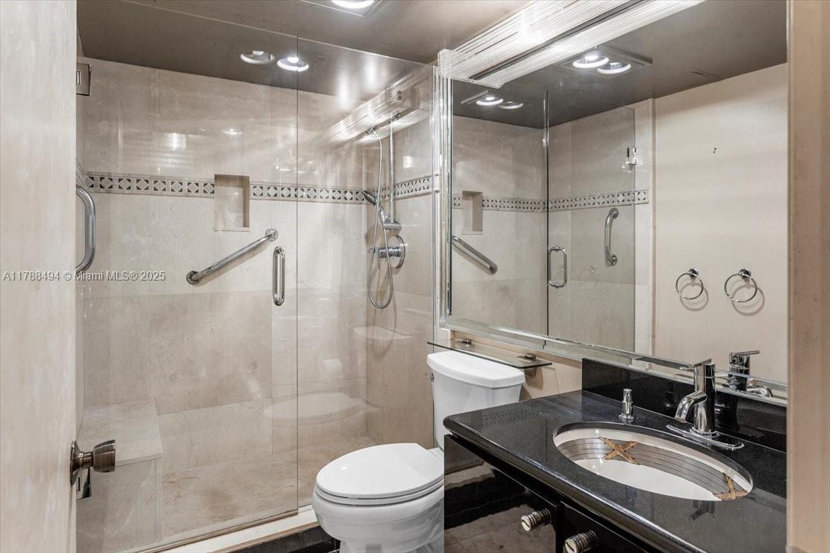 2808 North 46th Avenue, Unit E650 Hollywood, FL 33021 - Photo 24 of 45 a bathroom with a sink toilet a mirror and shower