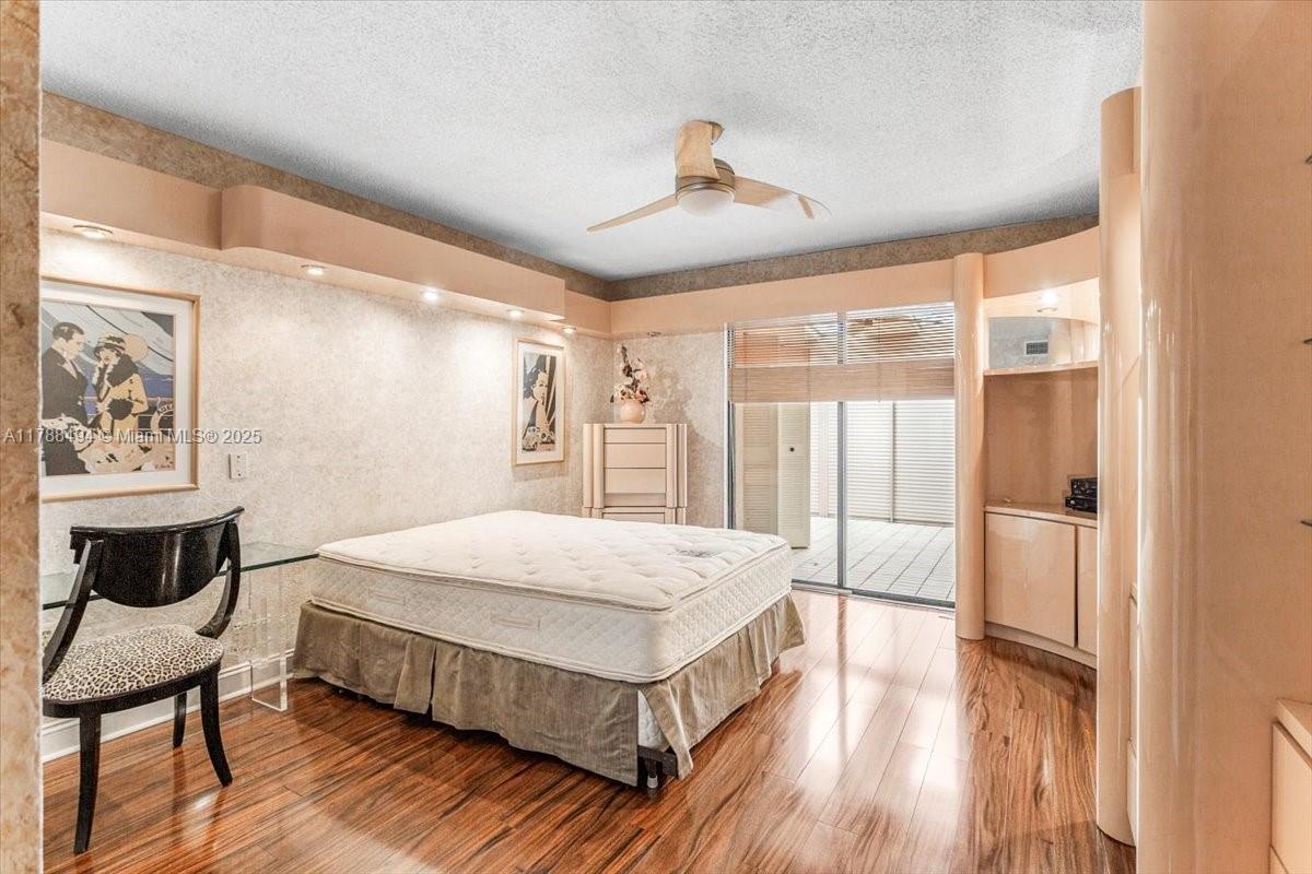 2808 North 46th Avenue, Unit E650 Hollywood, FL 33021 - Photo 25 of 45 a bedroom with a bed and wooden floor