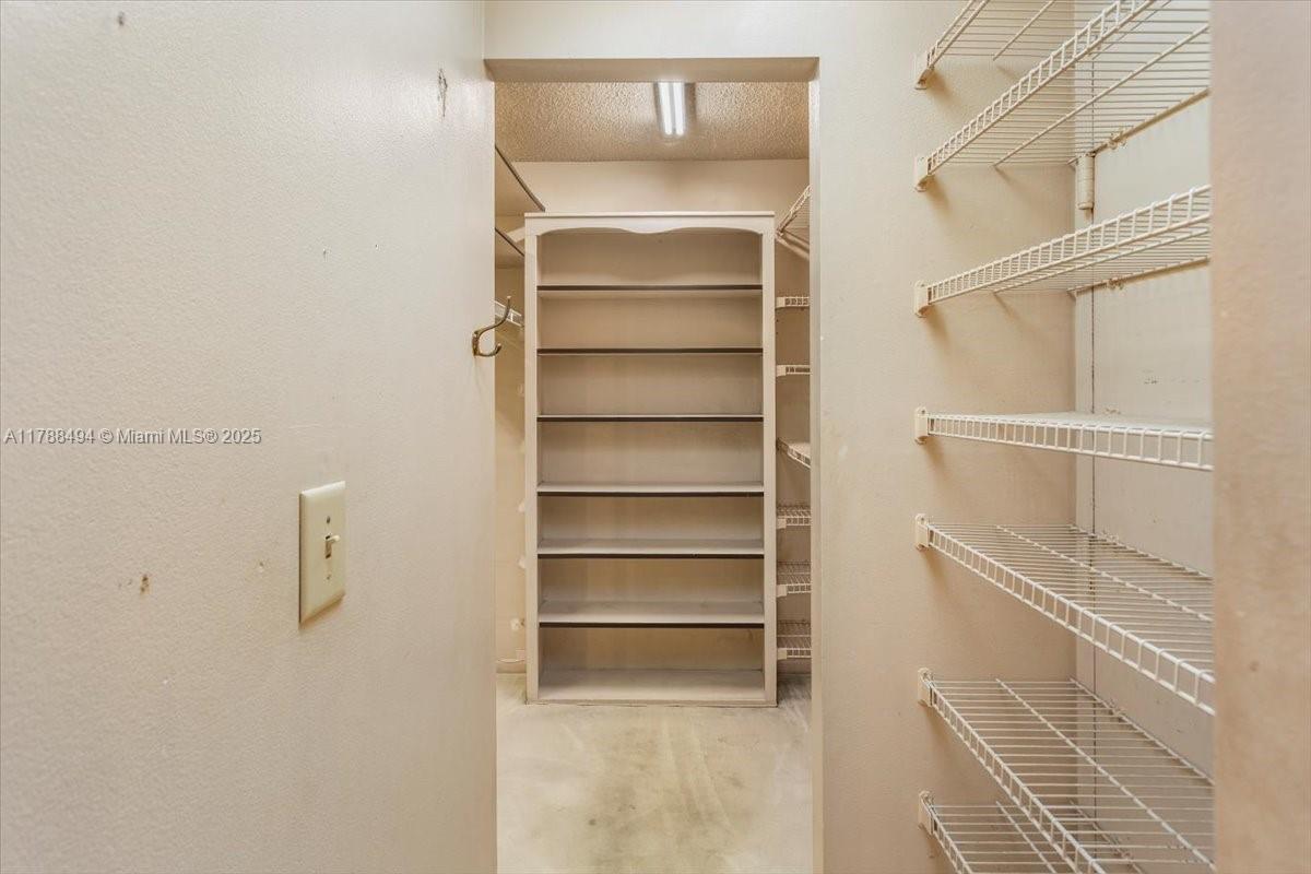 2808 North 46th Avenue, Unit E650 Hollywood, FL 33021 - Photo 33 of 45 a view of walk in closet with empty racks