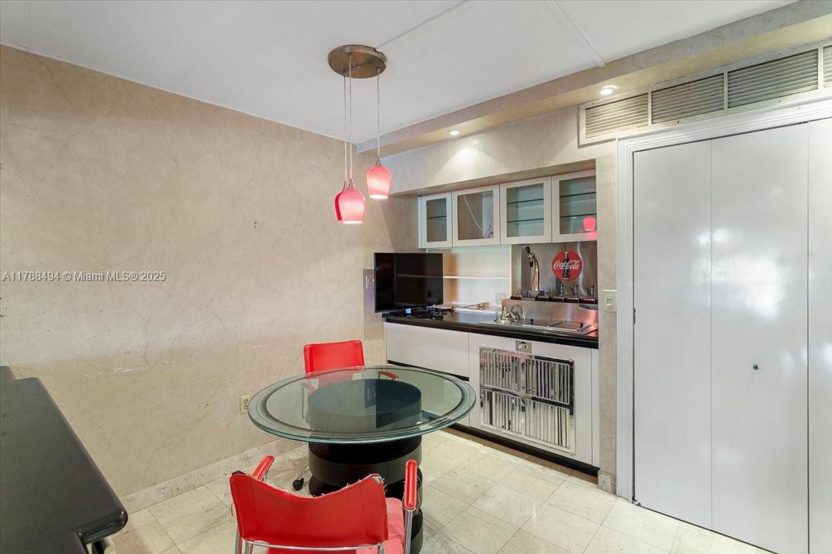 2808 North 46th Avenue, Unit E650 Hollywood, FL 33021 - Photo 6 of 45 a kitchen with stainless steel appliances kitchen island granite countertop a sink and a refrigerator
