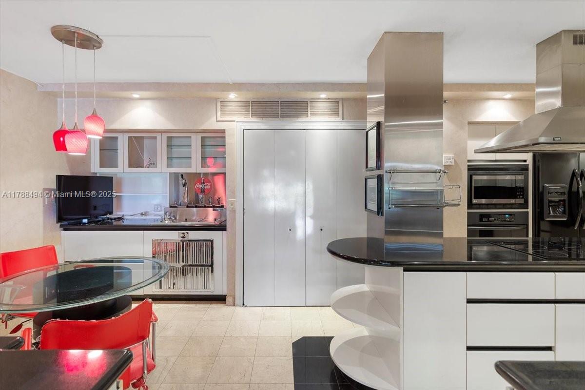 2808 North 46th Avenue, Unit E650 Hollywood, FL 33021 - Photo 7 of 45 a kitchen with stainless steel appliances kitchen island granite countertop a refrigerator and a stove