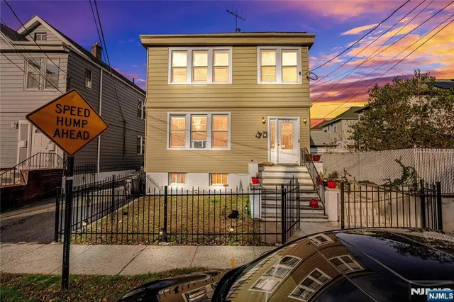 a view of a house with a wooden fence