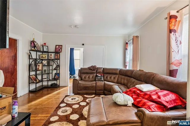 a living room with furniture a couch and bookshelf