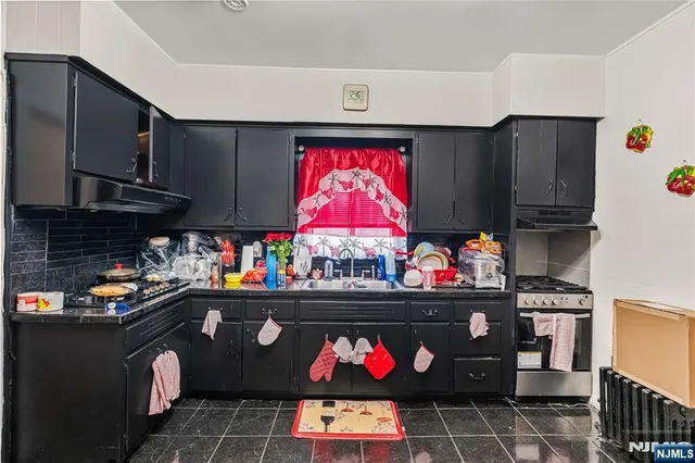 a kitchen with stainless steel appliances granite countertop a stove a microwave and cabinets