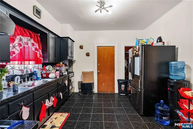 a kitchen area with stainless steel appliances a refrigerator and a stove
