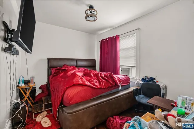 a bed sitting in a bedroom next to a window