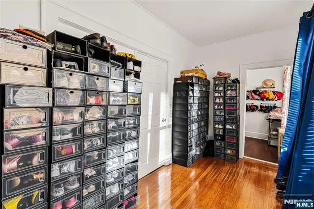 a view of walk in closet with clothes and shoes
