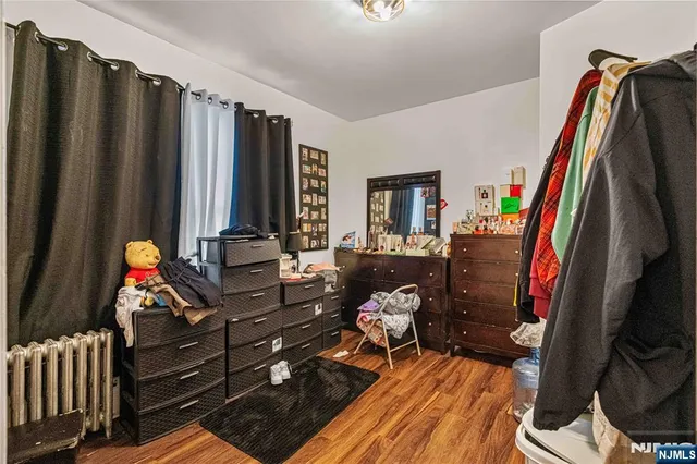 a living room with furniture a rug and a closet