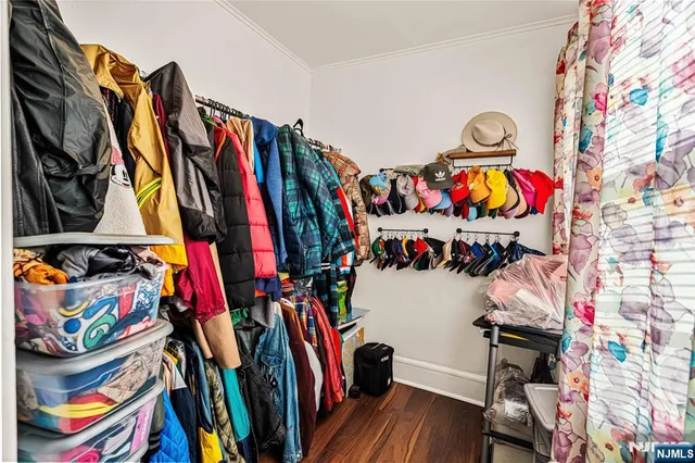 a view of walk in closet with clothes and shoes