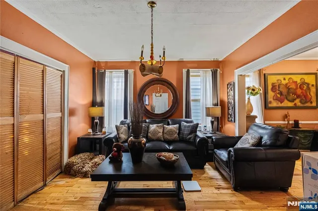 a living room with furniture a rug a ceiling fan and a large window