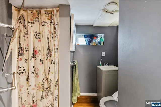 a bathroom with a toilet and a shower