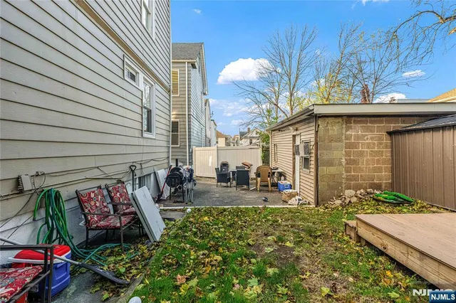 a view of a patio with table and chairs and potted plants
