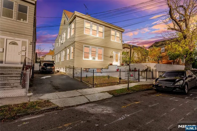 a street view with couple of cars parked on road
