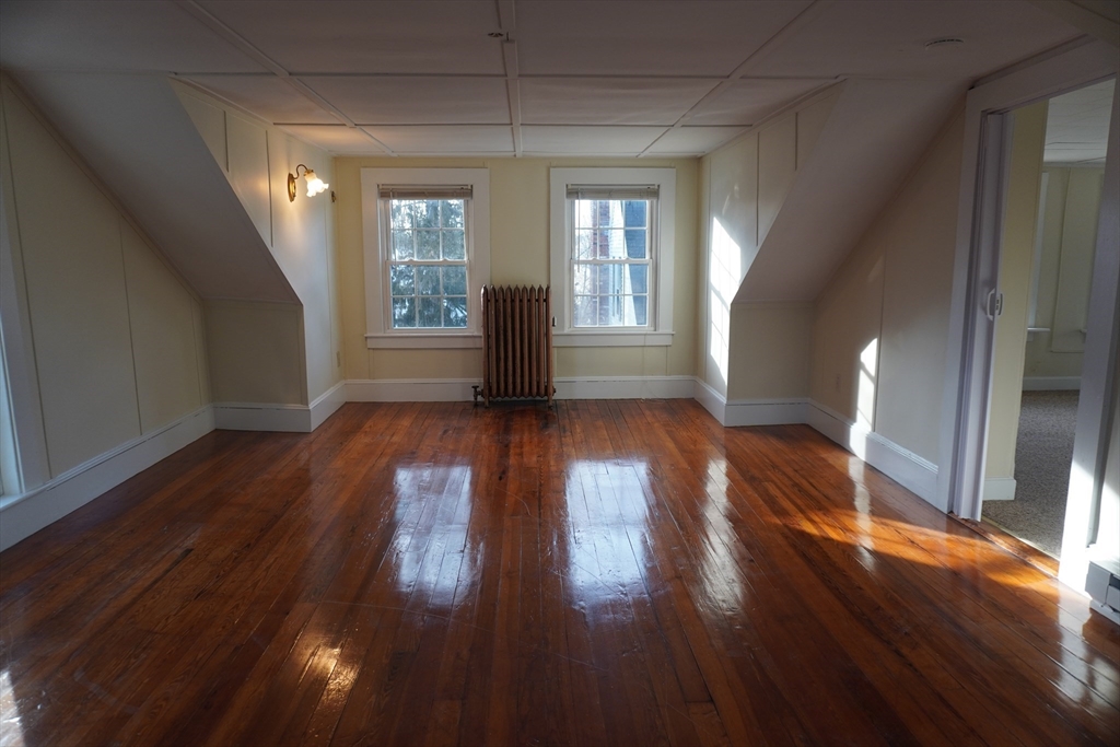 28 Court Street Mansfield, MA 02048 - Photo 13 of 39 a view of an empty room with wooden floor and a window