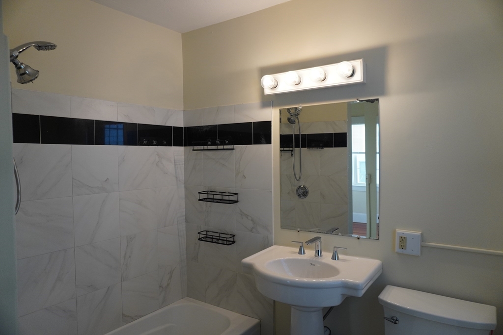 28 Court Street Mansfield, MA 02048 - Photo 23 of 39 a bathroom with a sink and a mirror