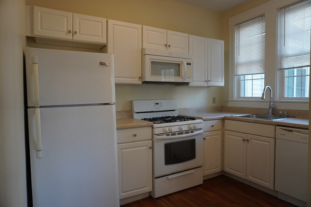 28 Court Street Mansfield, MA 02048 - Photo 25 of 39 a kitchen with stainless steel appliances white cabinets and a granite counter tops