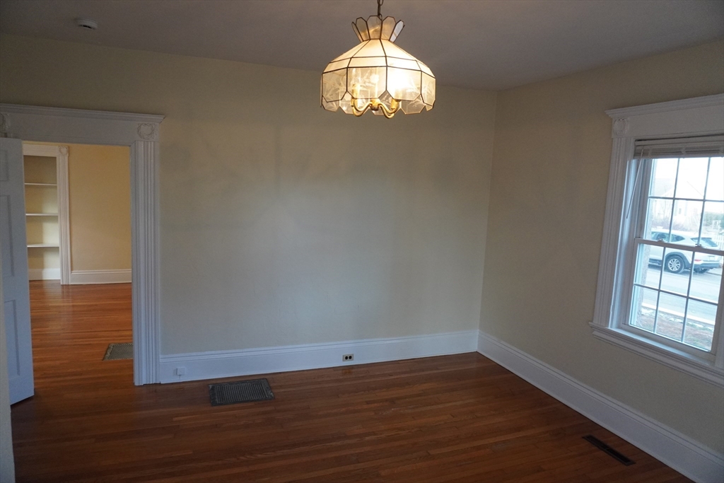 28 Court Street Mansfield, MA 02048 - Photo 33 of 39 an empty room with wooden floor and windows