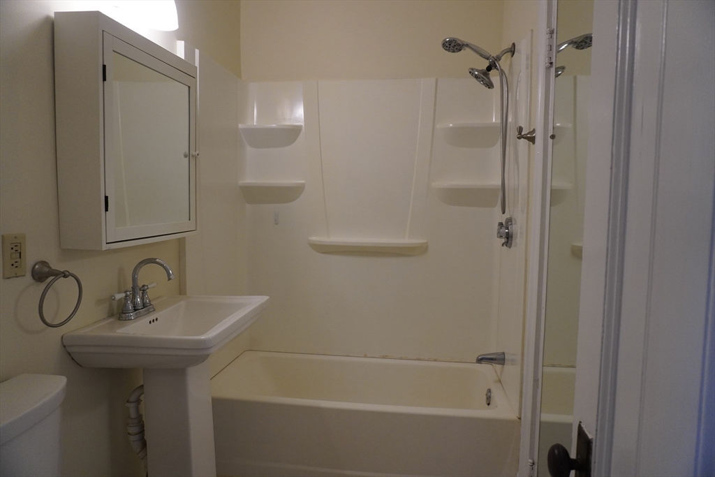 28 Court Street Mansfield, MA 02048 - Photo 5 of 39 a bathroom with a sink a toilet and shower