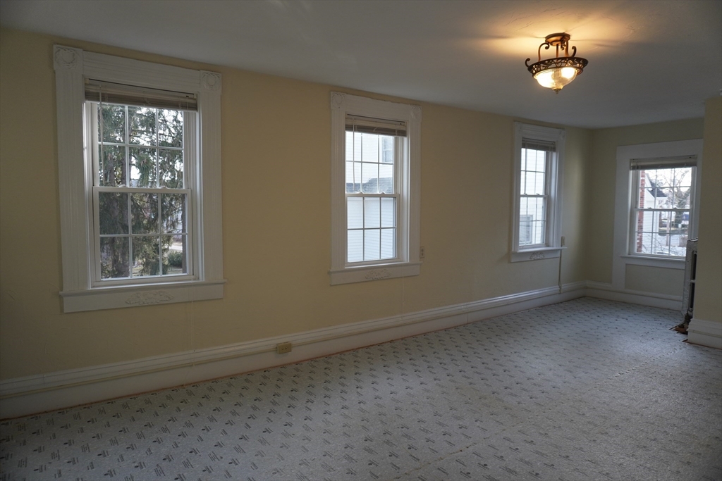 28 Court Street Mansfield, MA 02048 - Photo 8 of 39 a view of empty room with windows
