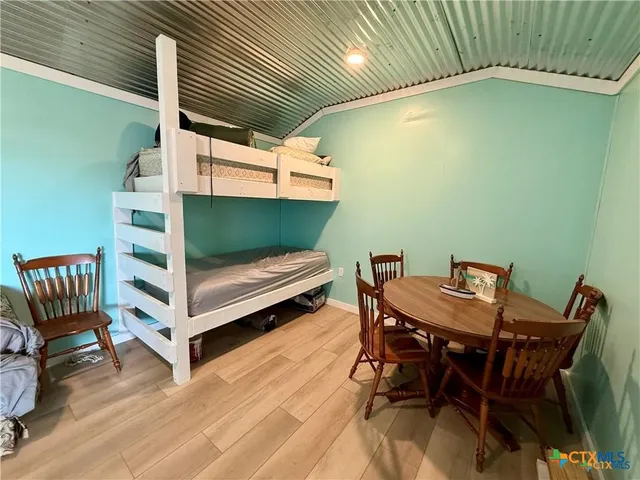 a backyard of a house with table and chairs