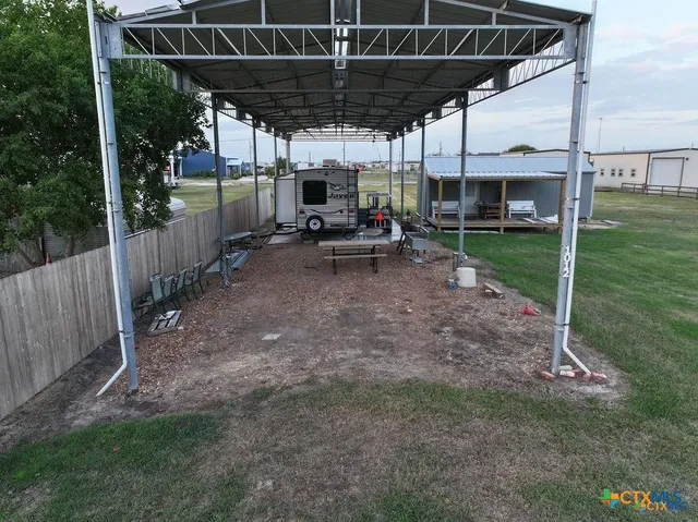 a view of a backyard with sitting area and furniture