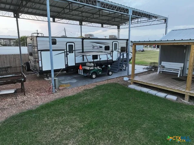an aerial view of a house with yard and lake view
