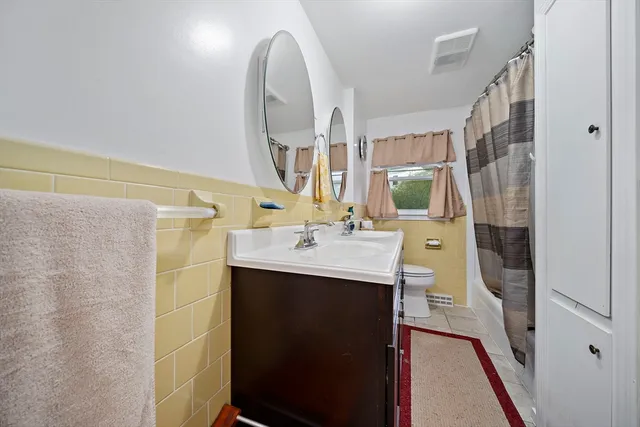 a bathroom with a sink vanity granite and a mirror