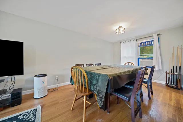 a dining room with furniture and wooden floor