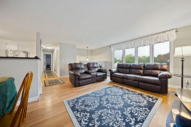 a living room with furniture rug and a table