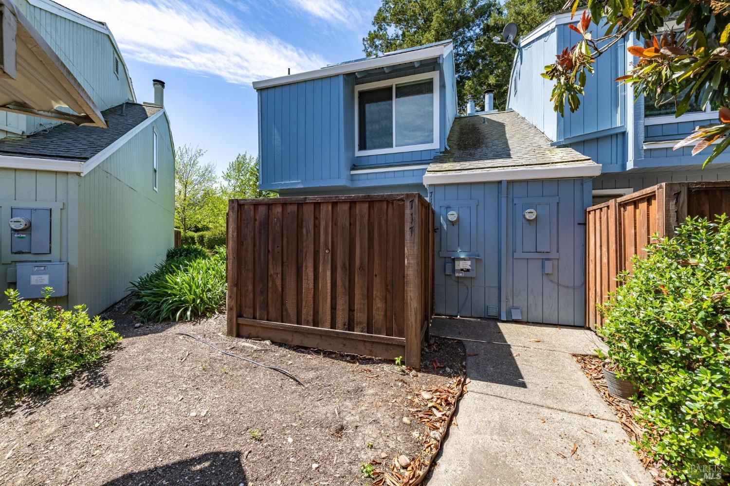 717 Racquet Club Circle Rohnert Park, CA 94928 - Photo 1 of 1 a view of backyard with potted plants and wooden fence