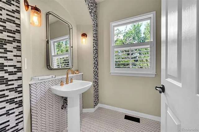 a bathroom with a sink a mirror and a shower