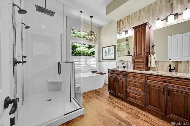 a spacious bathroom with a shower sink and mirror