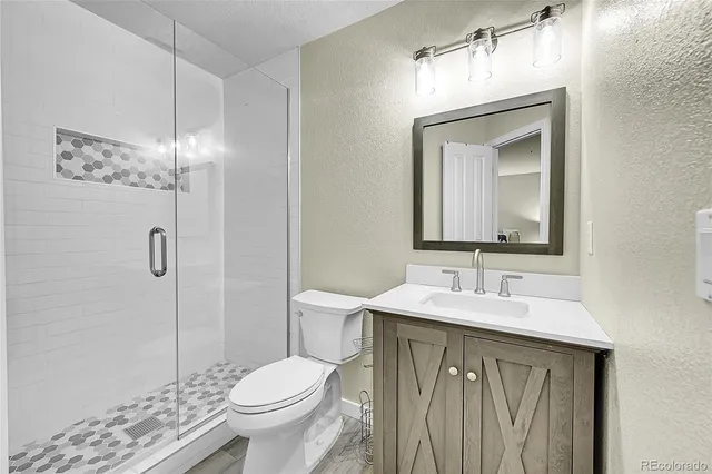 a bathroom with a toilet sink and shower