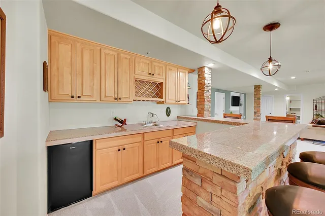 a kitchen with stainless steel appliances granite countertop a sink a stove and a wooden floors