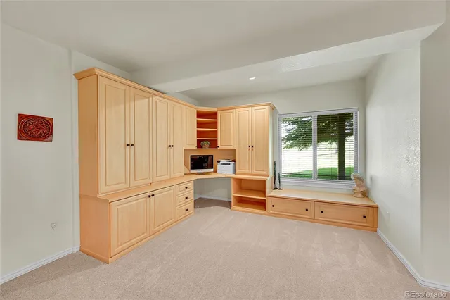 a view of a bedroom with furniture and windows