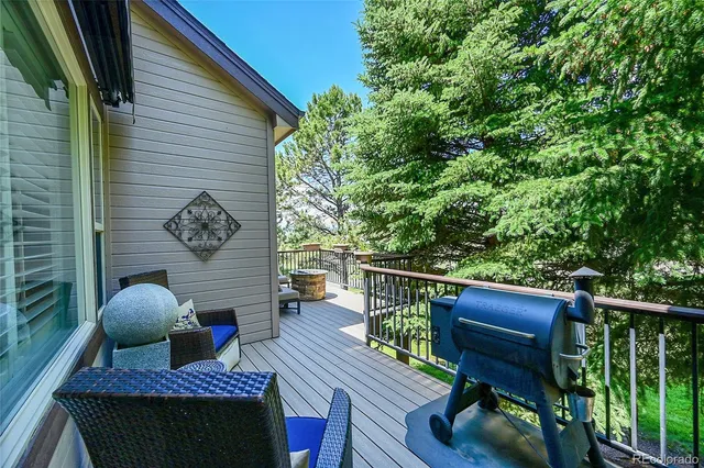 a view of balcony with wooden floor and outdoor seating