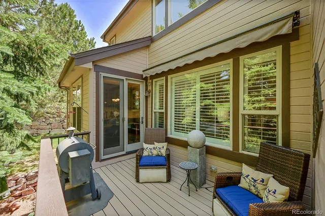 a balcony with furniture and a potted plant