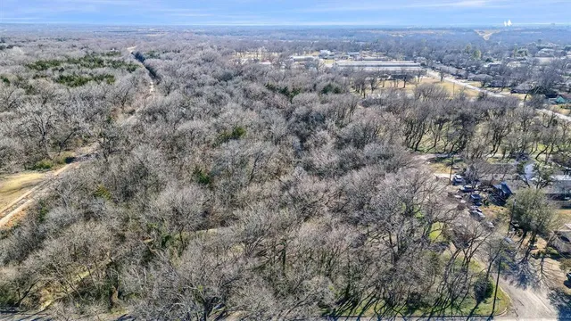 an aerial view of house with yard and mountain view in back