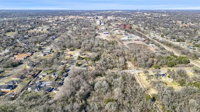 an aerial view of residential houses with city view