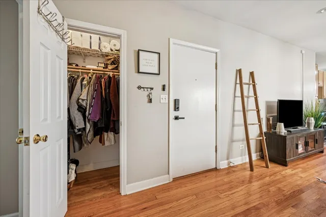 a view of a livingroom with wooden floor and a flat screen tv