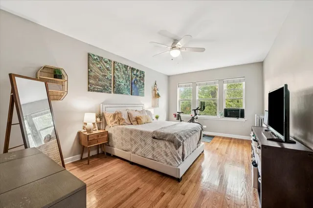 a bedroom with a bed window and a flat screen tv