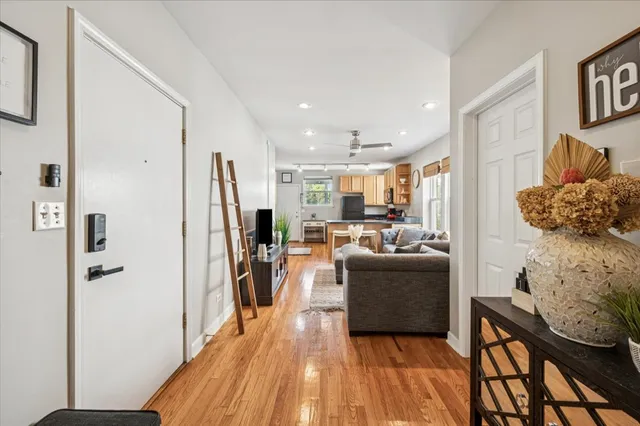a living room with furniture and a wooden floor