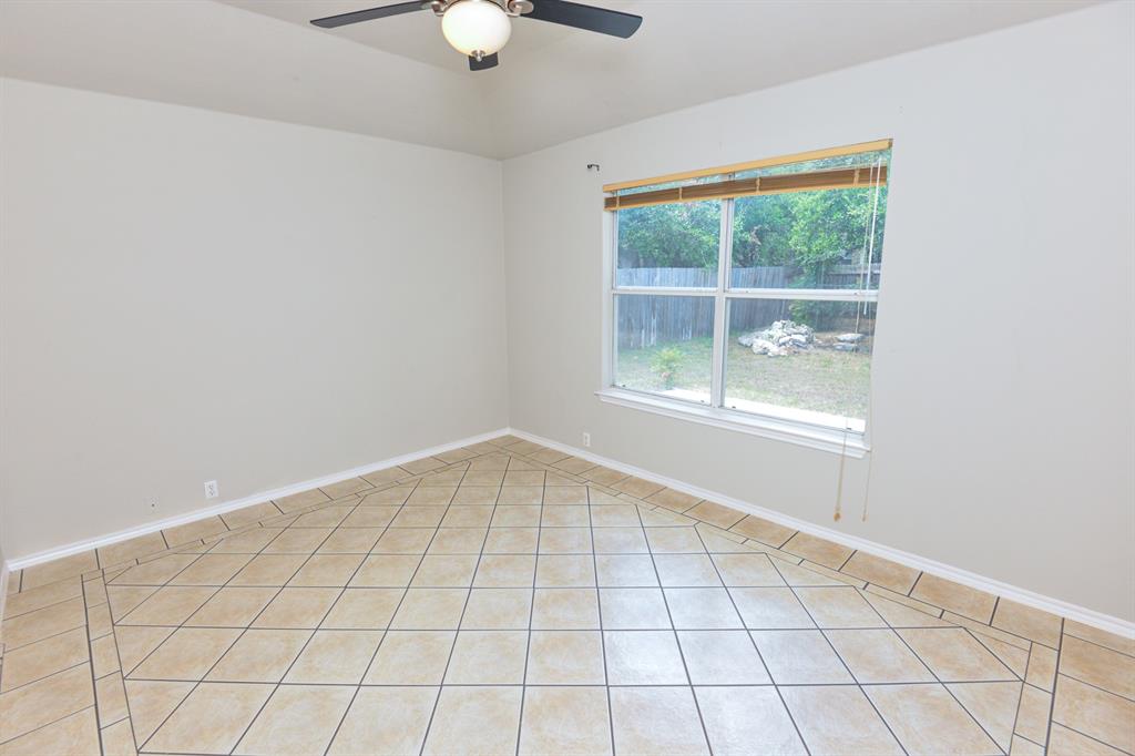 2109 Kimra Lane Cedar Park, TX 78613 - Photo 16 of 31 Empty room with light tile patterned flooring and baseboards