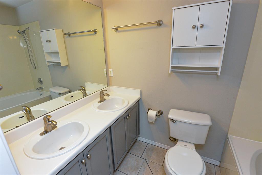 2109 Kimra Lane Cedar Park, TX 78613 - Photo 17 of 31 Full bathroom with shower combination, double vanity, and light tile patterned floors